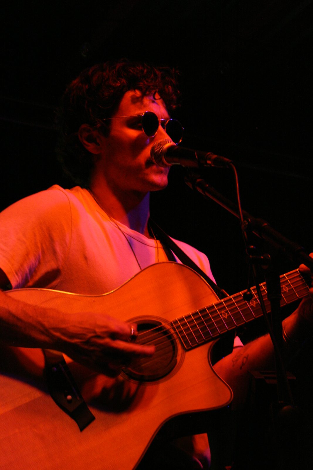 Greyson Turner mid-set under red stage light